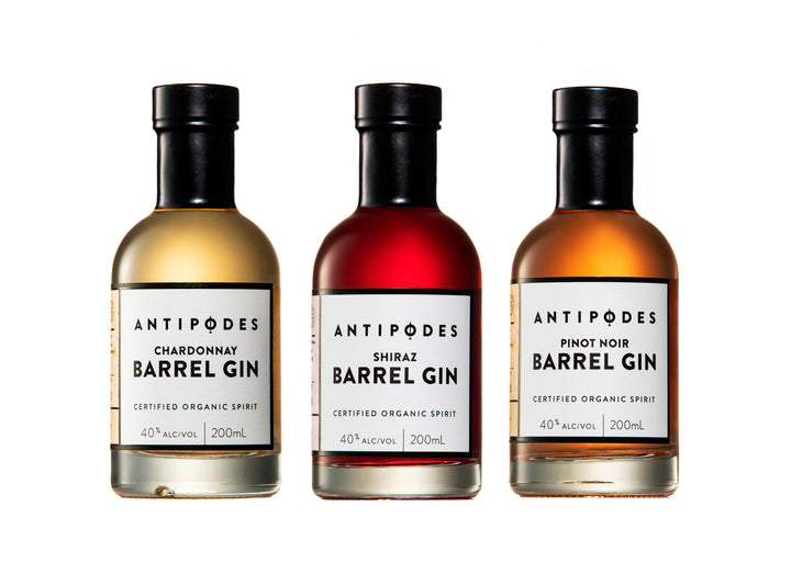 Three bottles of Antipodes Barrel Gin on a white background
