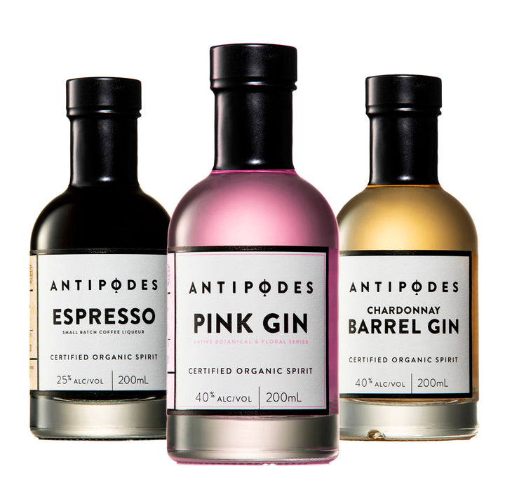 Three bottles of Antipodes gin with different flavors on a white background
