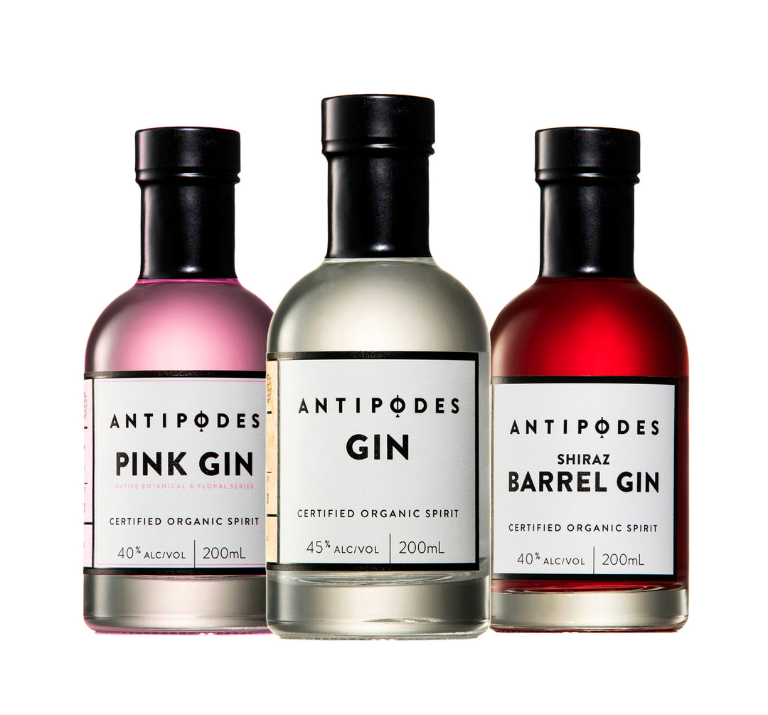 Three bottles of Antipodes gin with different flavors on a white background