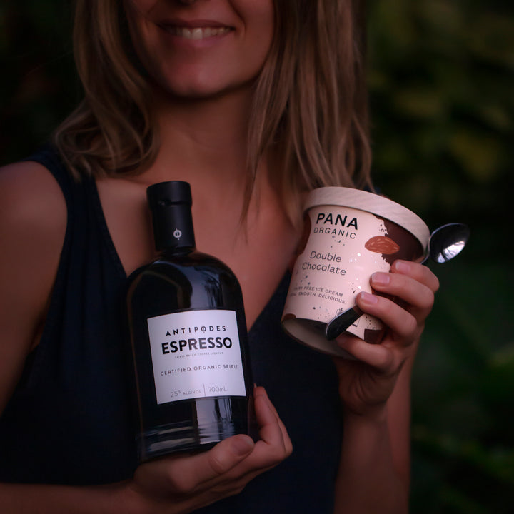 Person holding a bottle labeled &