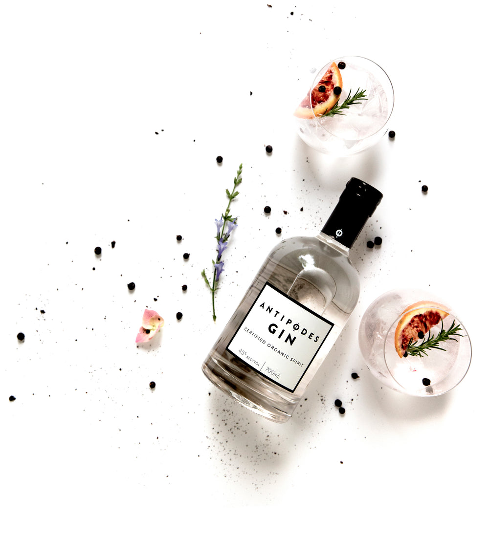 Antipodes Gin bottle with two cocktails on a white background
