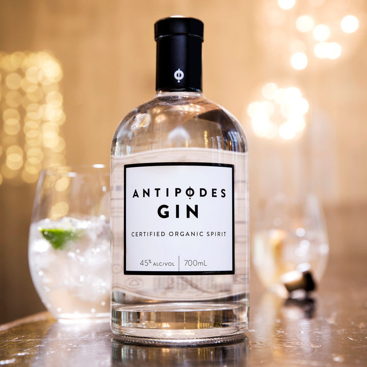 Antipodes Gin bottle on a bar with blurred lights in the background