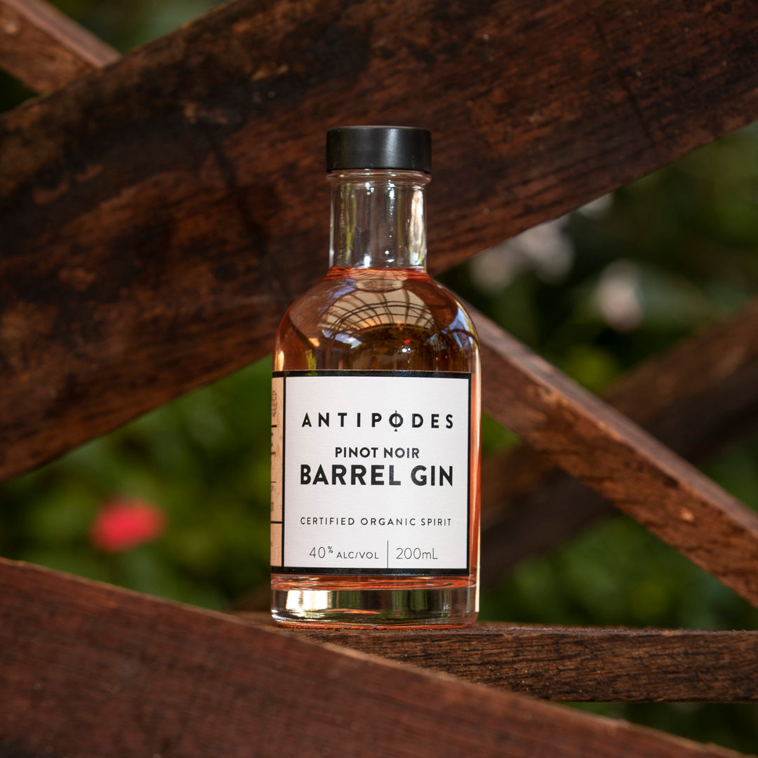 Bottle of Antipodes Pinot Noir Barrel Gin on a wooden background