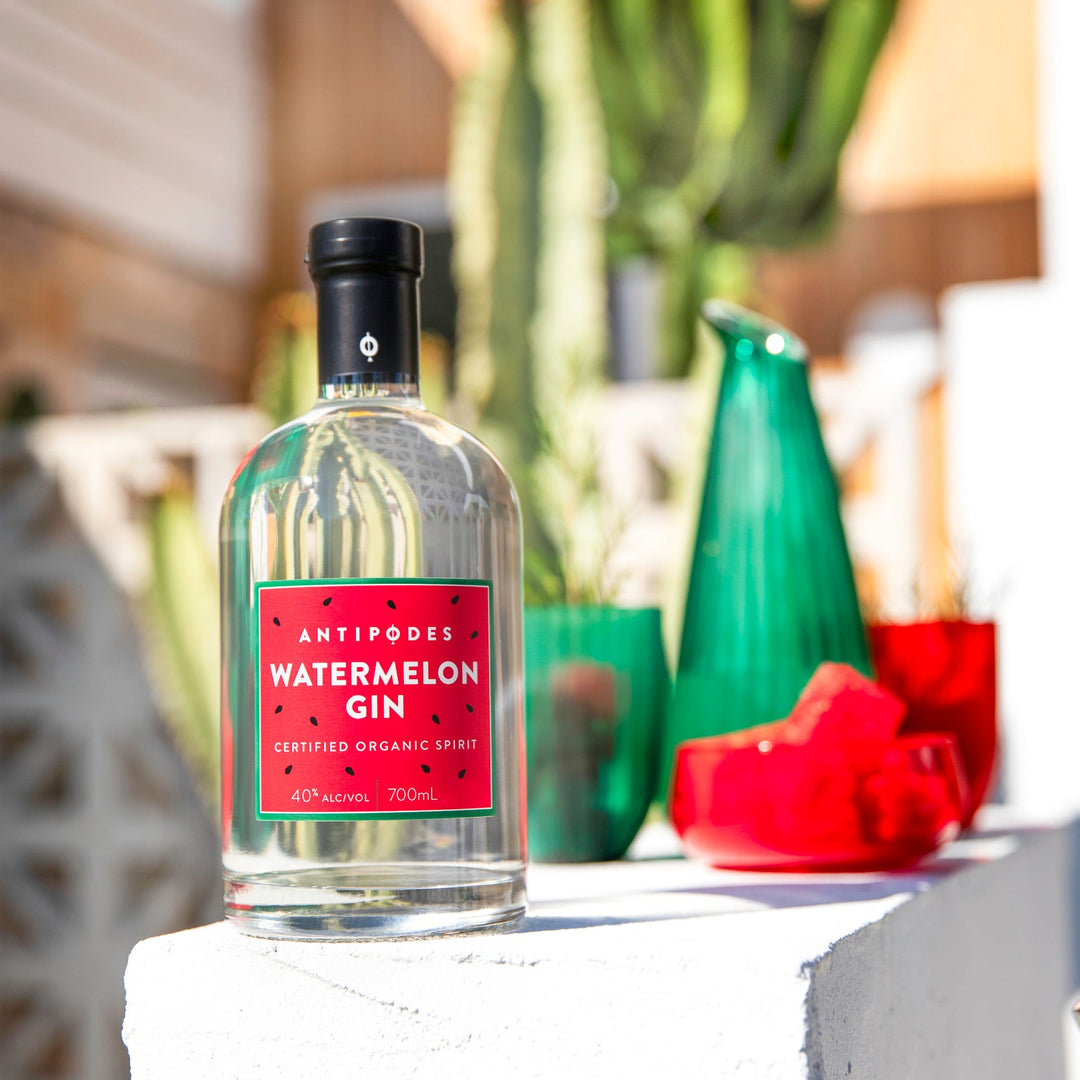 Bottle of watermelon gin on a surface with a blurred background